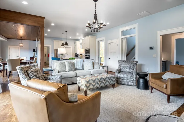 a living room with furniture and a chandelier