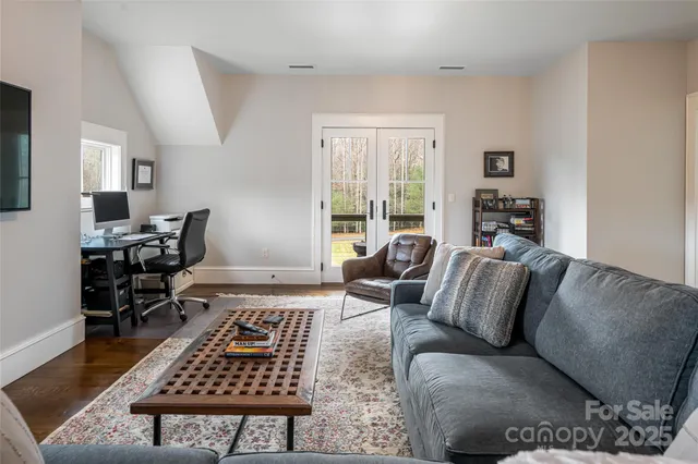 a living room with furniture a rug and a table