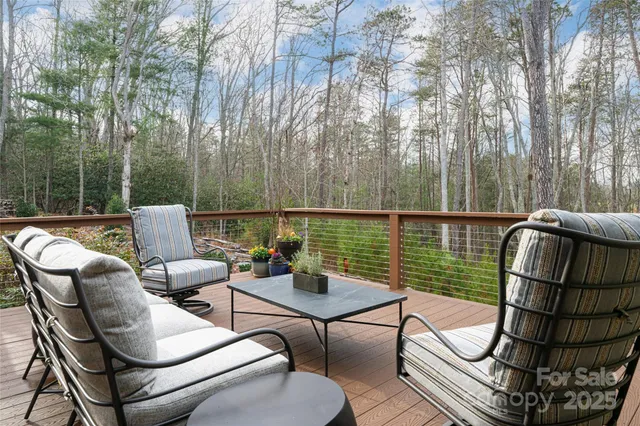 a view of a patio with couches chairs and a wooden floor
