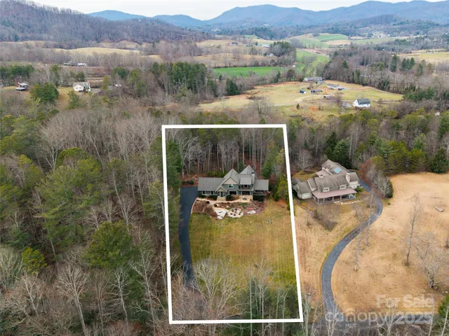 a view of a house with pool and sitting area