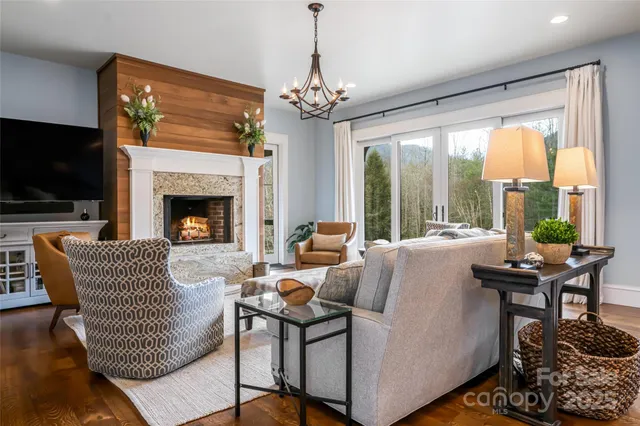 a living room with furniture a flat screen tv and a large window