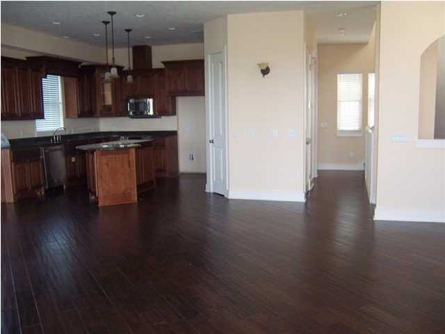 27 Pompano Ct Inlet Beach Inlet Beach, FL 32461 - Photo 2 of 23 a kitchen with kitchen island granite countertop wooden floors and a sink