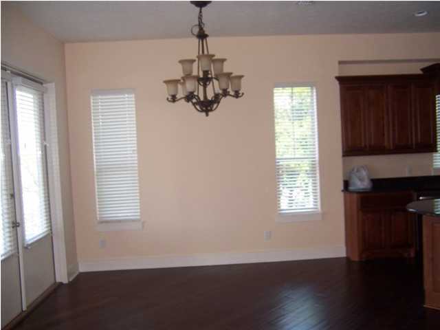27 Pompano Ct Inlet Beach Inlet Beach, FL 32461 - Photo 8 of 23 a view of an empty room with wooden floor and a window