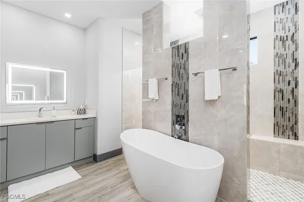 a bathroom with a bathtub and shower