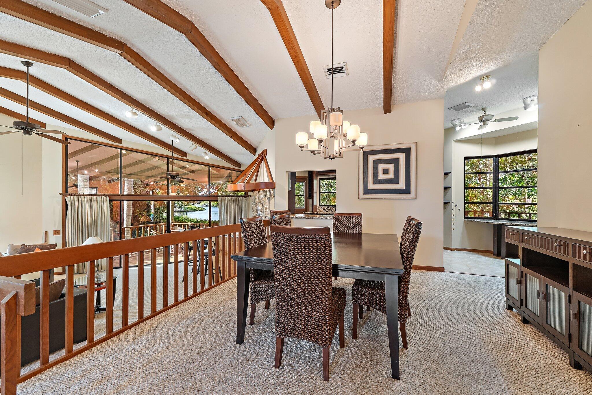 702 Warren Drive Jupiter, FL 33458 - Photo 34 of 76 a view of a dining room with furniture window and chandelier