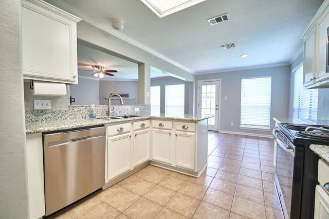 a kitchen with a sink stove and cabinets