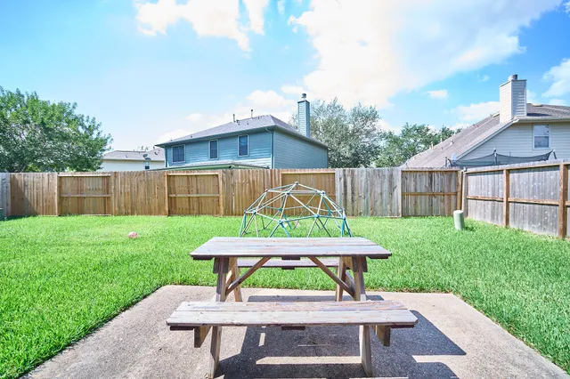 a view of a yard with a table and a chairs