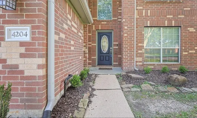 a pathway of a house with a porch