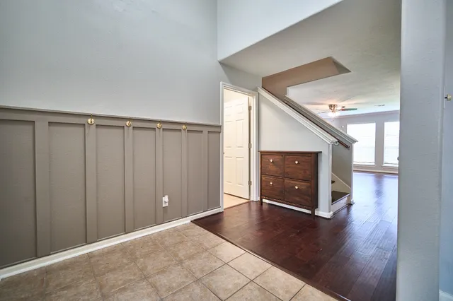 a view of an empty room with wooden floor