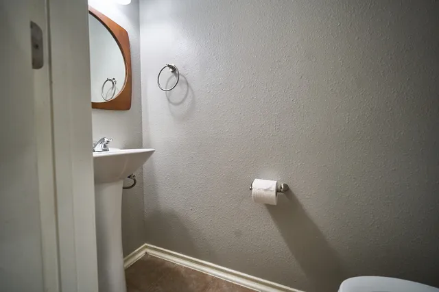 a bathroom with a toilet and a mirror