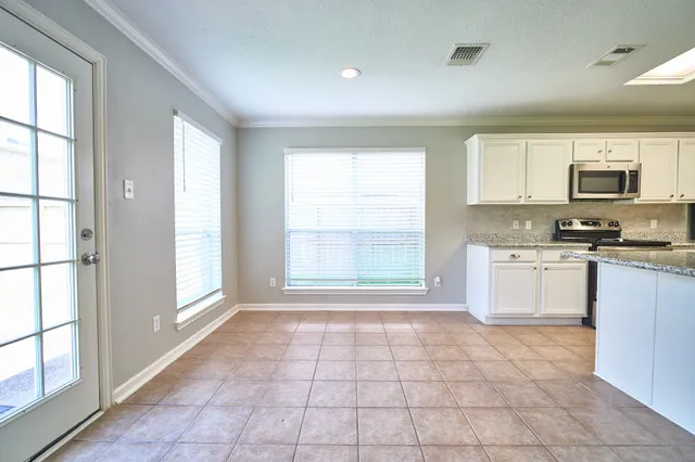 a kitchen with a stove a sink and a refrigerator