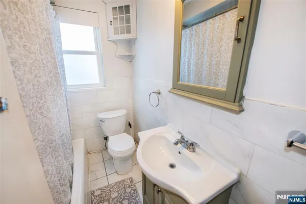 a bathroom with a sink toilet and mirror