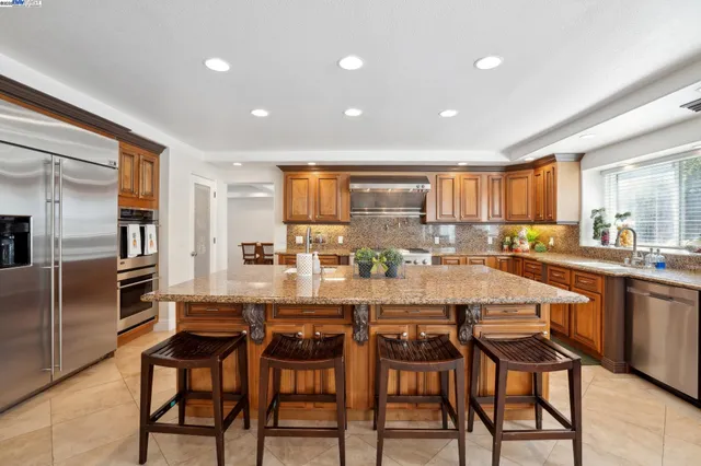 a large kitchen with a table and chairs