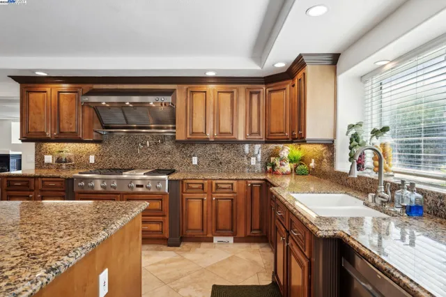 a kitchen with a sink stove top oven and cabinets
