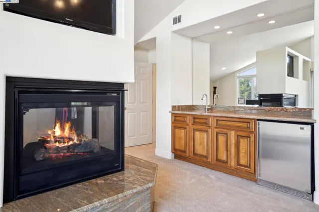 a spacious bathroom with a granite countertop tub and a large window
