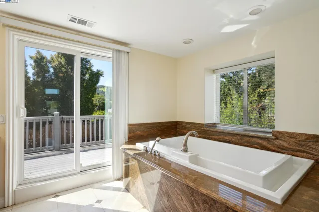 a living room with furniture a mirror and a table