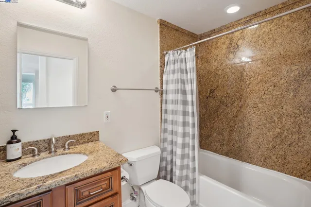 a view of a backyard with plants and outdoor seating