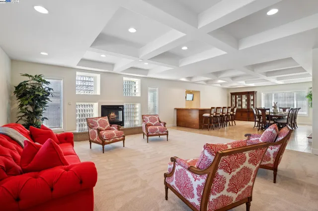 a living room with furniture kitchen view and a fireplace