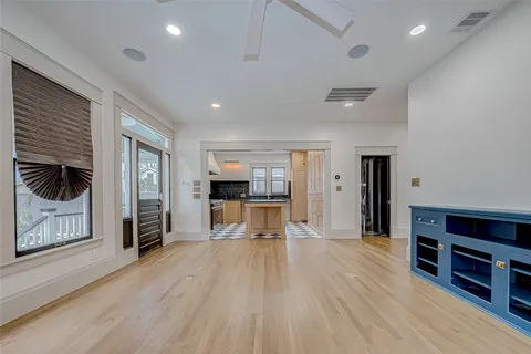 an empty room with windows and cabinet