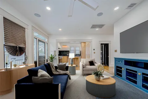 an empty room with wooden floor and entrance to ceiling window