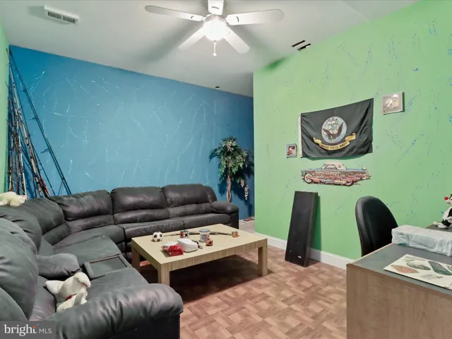 a work room with furniture and a wooden floor