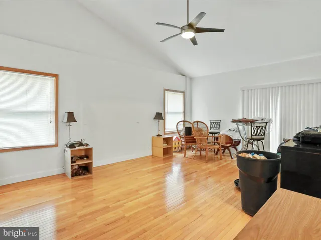 a kitchen with stainless steel appliances kitchen island granite countertop a table chairs and a refrigerator