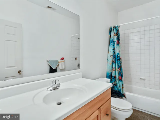 a view of a white house with a yard