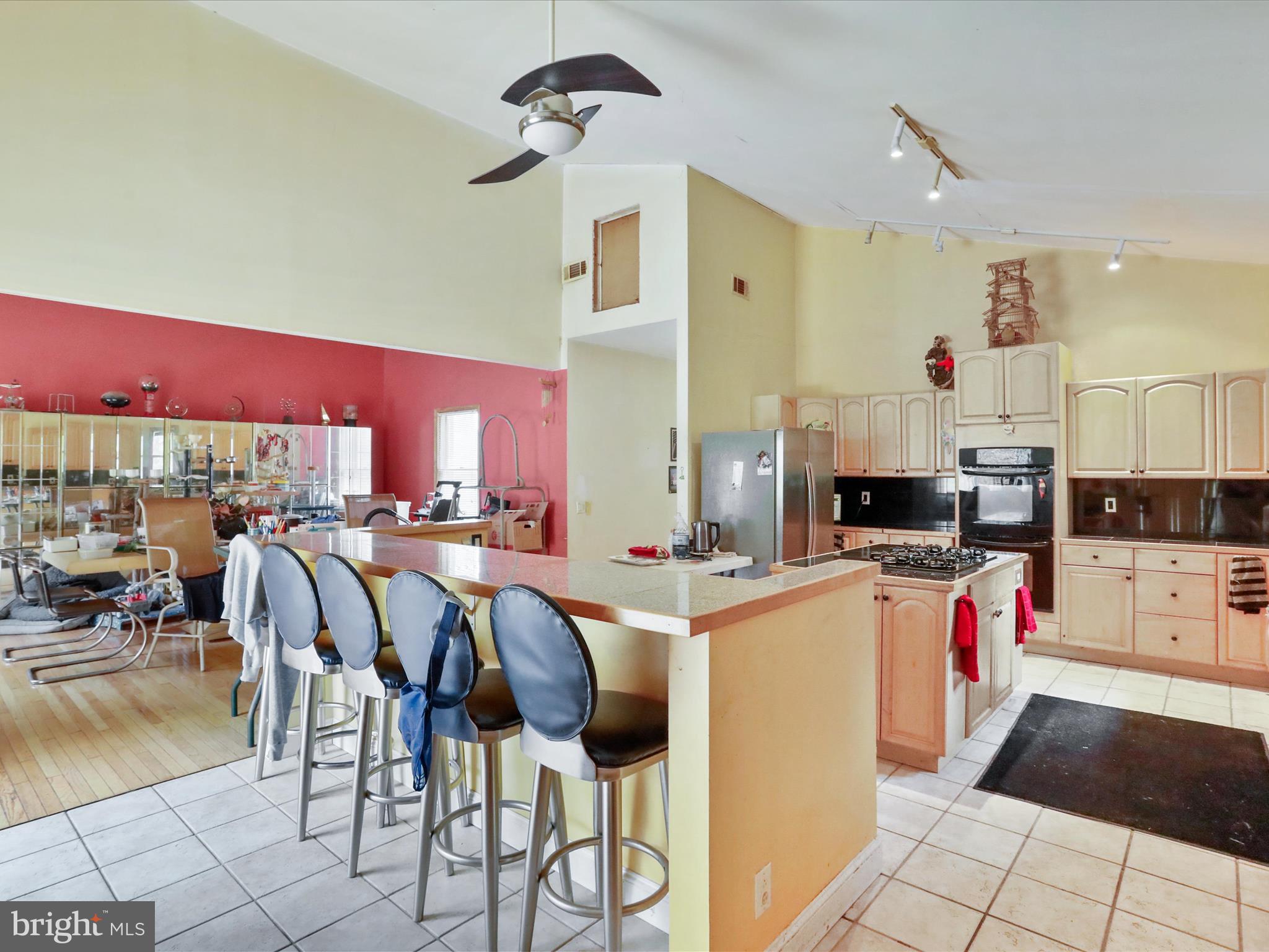 525 Rolling Rock Road Star Tannery, VA 22654 - Photo 41 of 69 a kitchen with stainless steel appliances kitchen island granite countertop a table chairs and a refrigerator