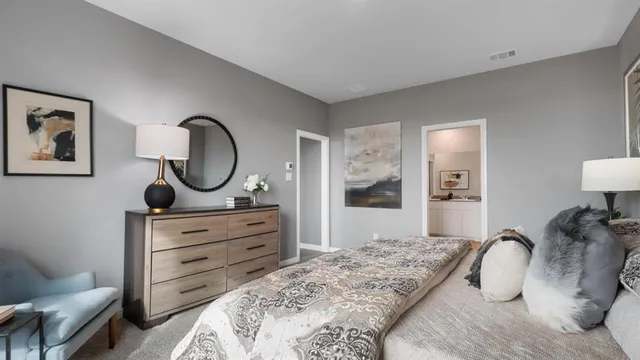 a bedroom with a bed and a chair