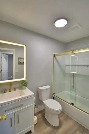 a bathroom with a toilet and a shower