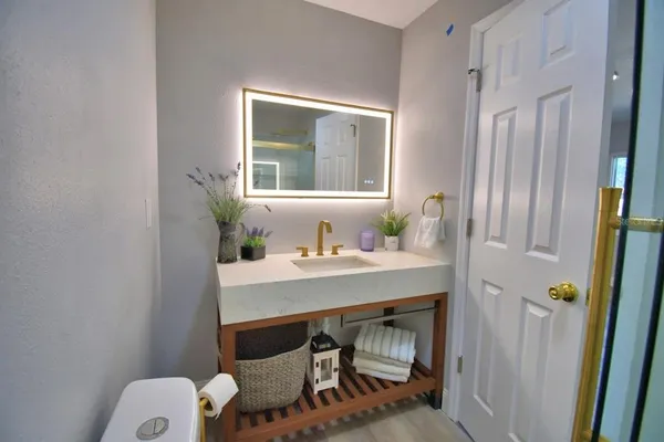 a white toilet sitting next to a bathroom sink