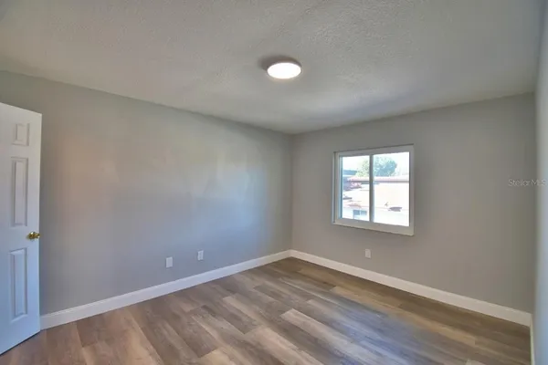 a view of an empty room and bathroom