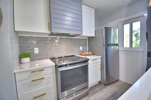 a kitchen with a sink cabinets and wooden floor