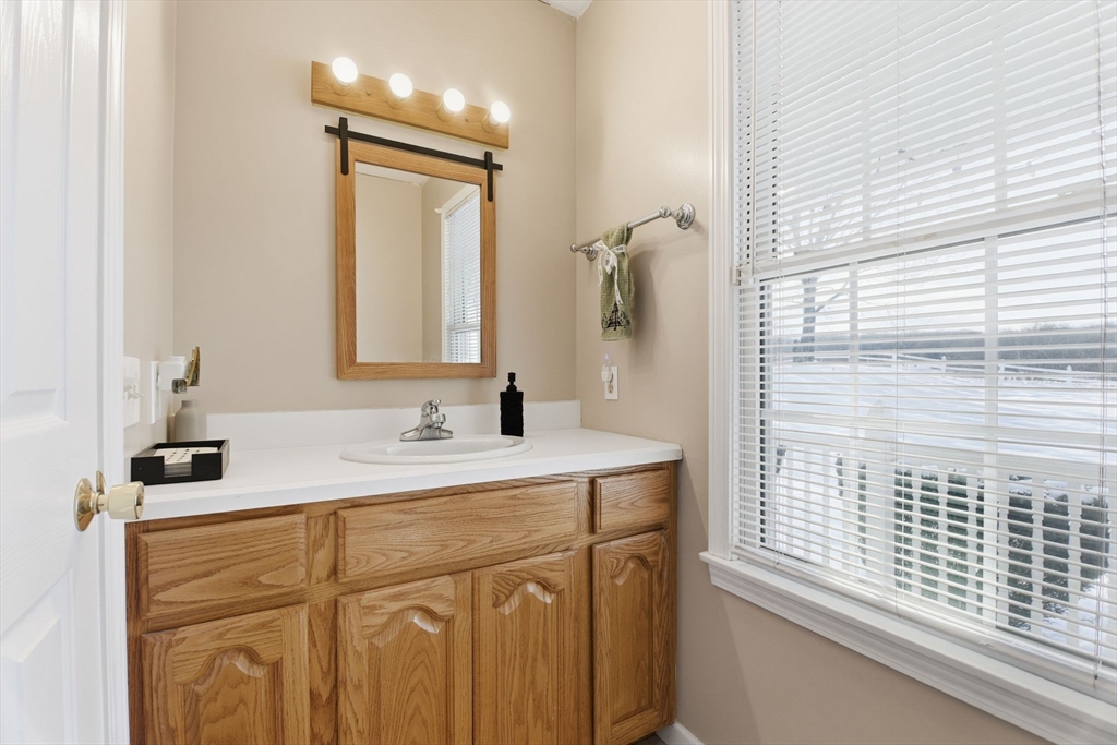 2 John Mason Road Southwick, MA 01077 - Photo 18 of 41 a bathroom with a sink a vanity and a mirror