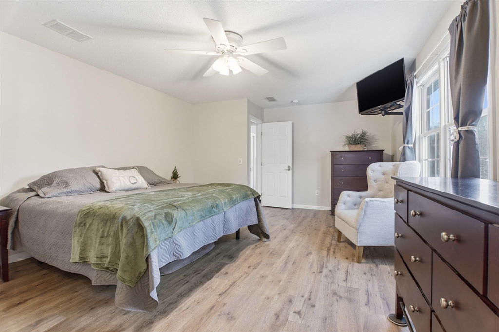 2 John Mason Road Southwick, MA 01077 - Photo 21 of 41 a spacious bedroom with a bed and a flat screen tv