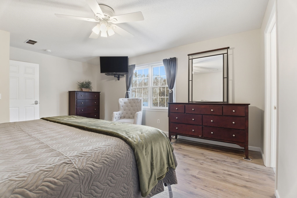 2 John Mason Road Southwick, MA 01077 - Photo 22 of 41 a bedroom with a bed and a flat screen tv