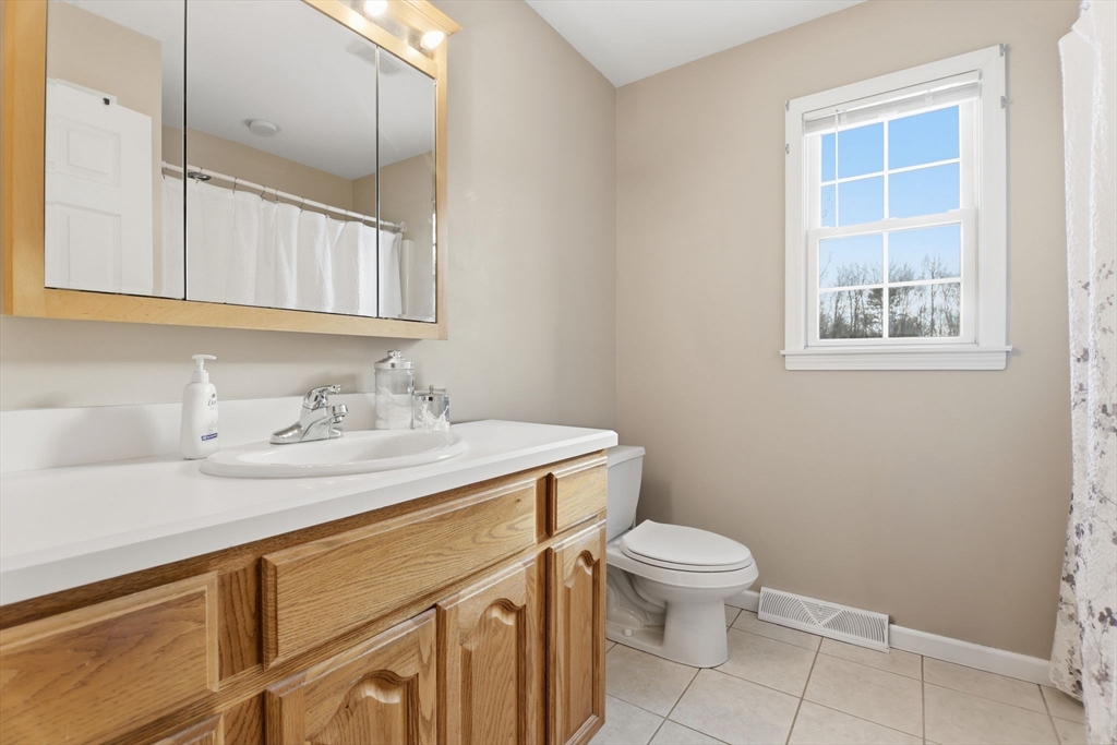 2 John Mason Road Southwick, MA 01077 - Photo 24 of 41 a bathroom with a granite countertop sink a toilet and a mirror