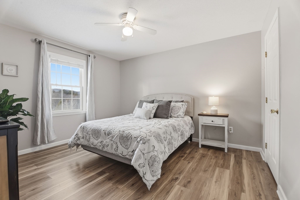2 John Mason Road Southwick, MA 01077 - Photo 25 of 41 a bedroom with a bed and a potted plant on the dresser