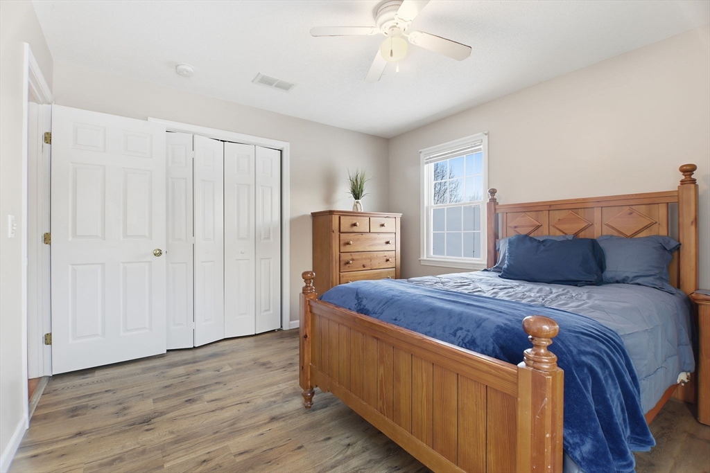2 John Mason Road Southwick, MA 01077 - Photo 29 of 41 a bedroom with a bed and a chandelier