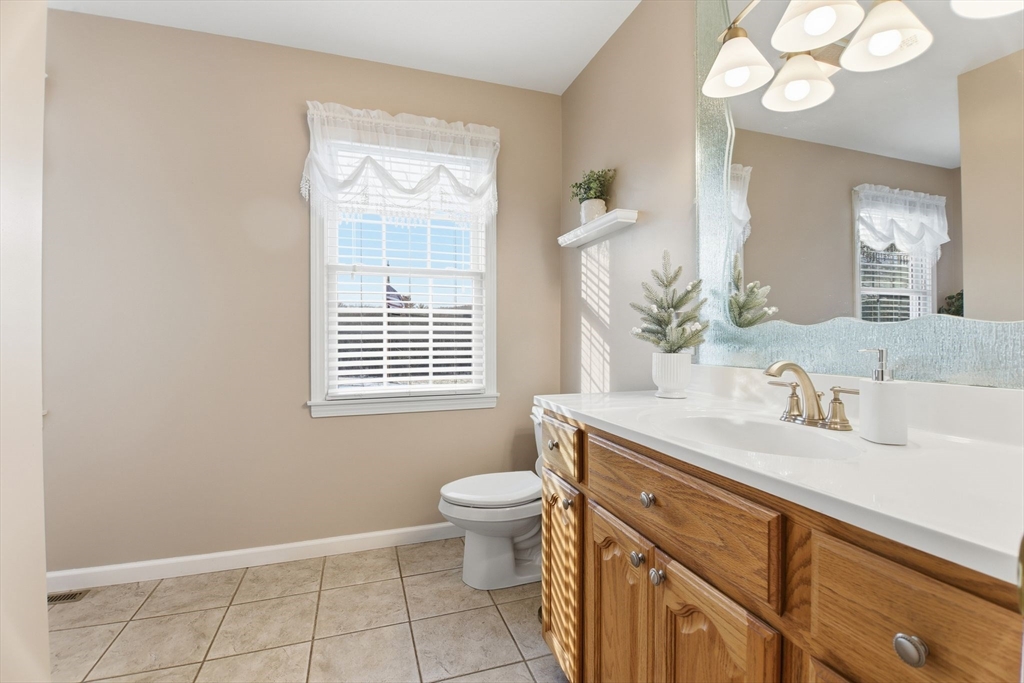 2 John Mason Road Southwick, MA 01077 - Photo 34 of 41 a bathroom with a granite countertop sink a toilet and a mirror