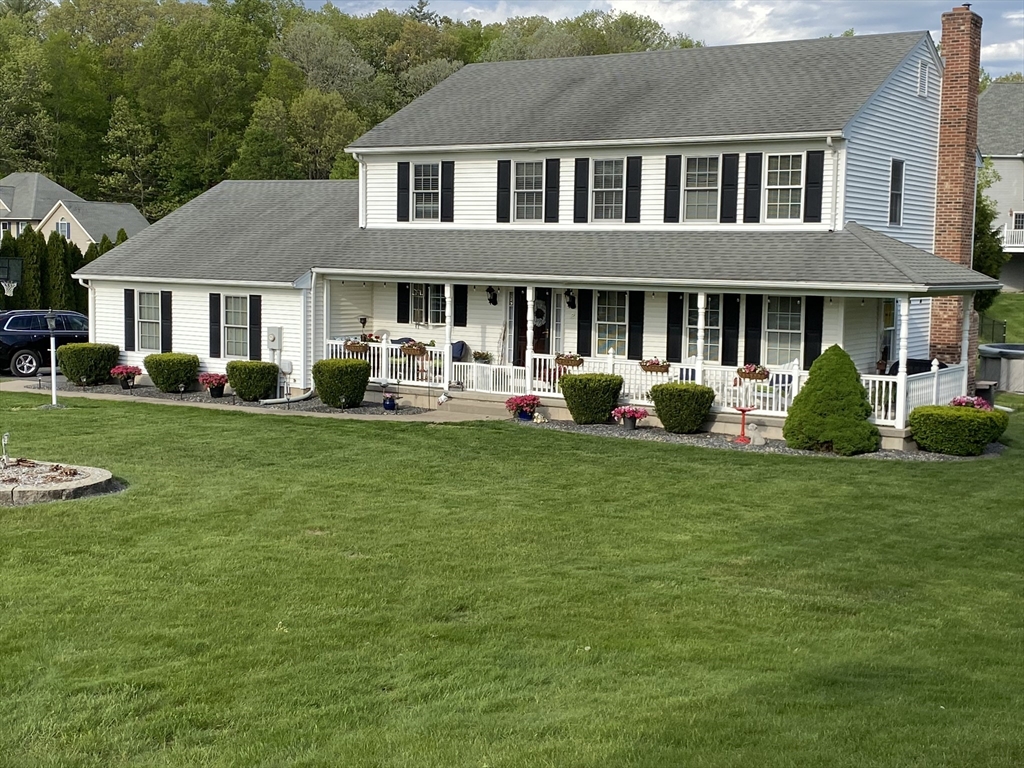 2 John Mason Road Southwick, MA 01077 - Photo 39 of 41 a front view of a house with garden and trees