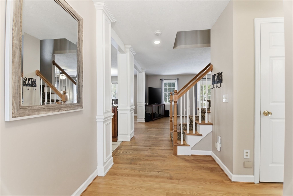 2 John Mason Road Southwick, MA 01077 - Photo 6 of 41 a view of a hallway with wooden floor and staircase