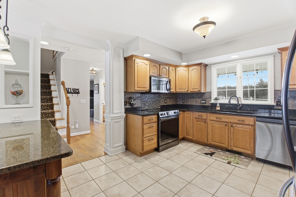 2 John Mason Road Southwick, MA 01077 - Photo 9 of 41 a kitchen with stainless steel appliances granite countertop a stove sink and cabinets
