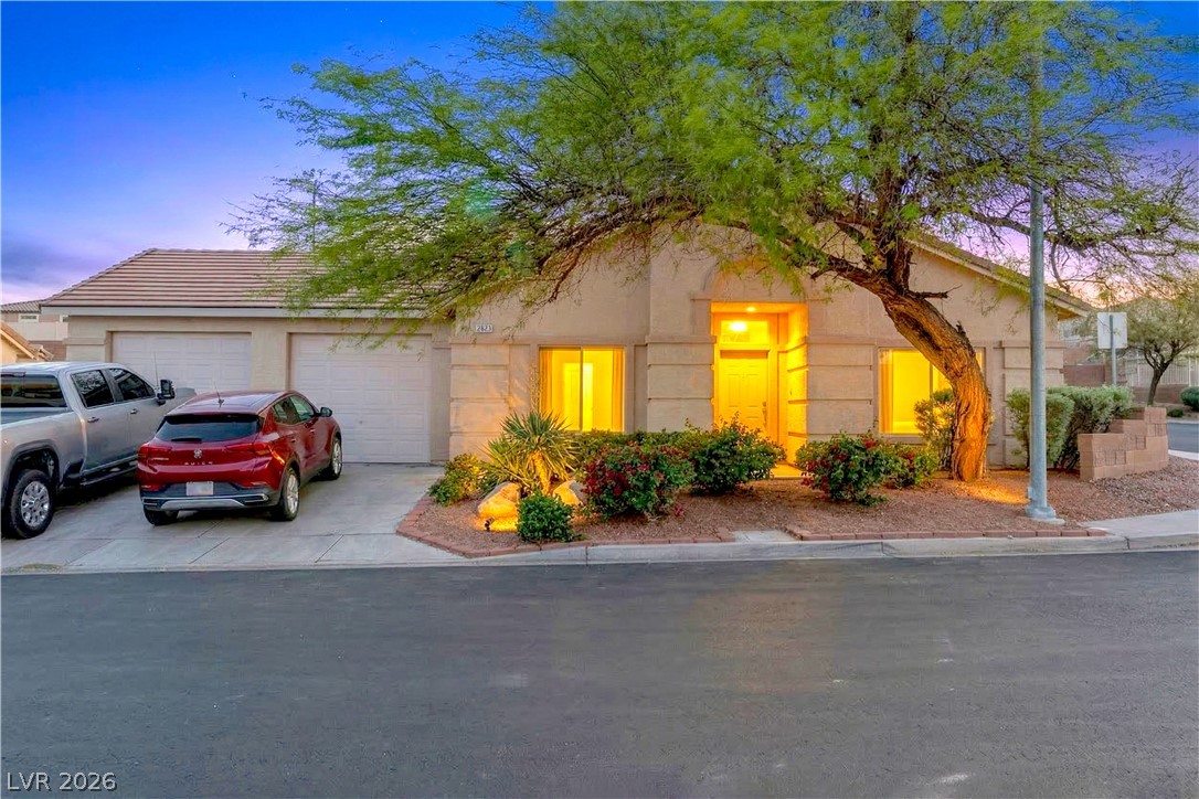 2823 Rippling Springs Street Laughlin, NV 89029 - Photo 2 of 89 View of front of house featuring driveway, stucco siding, and an attached garage