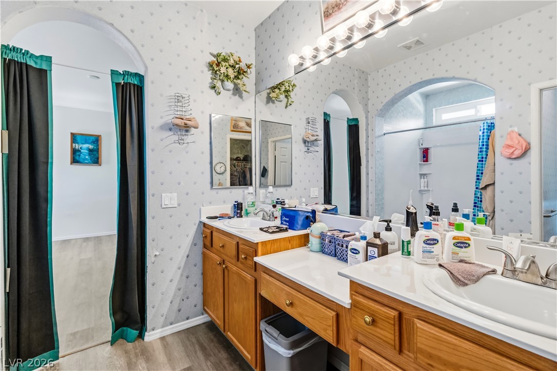 2823 Rippling Springs Street Laughlin, NV 89029 - Photo 35 of 89 Primary Bathroom featuring light wood finished floors, vanity, and wallpapered walls