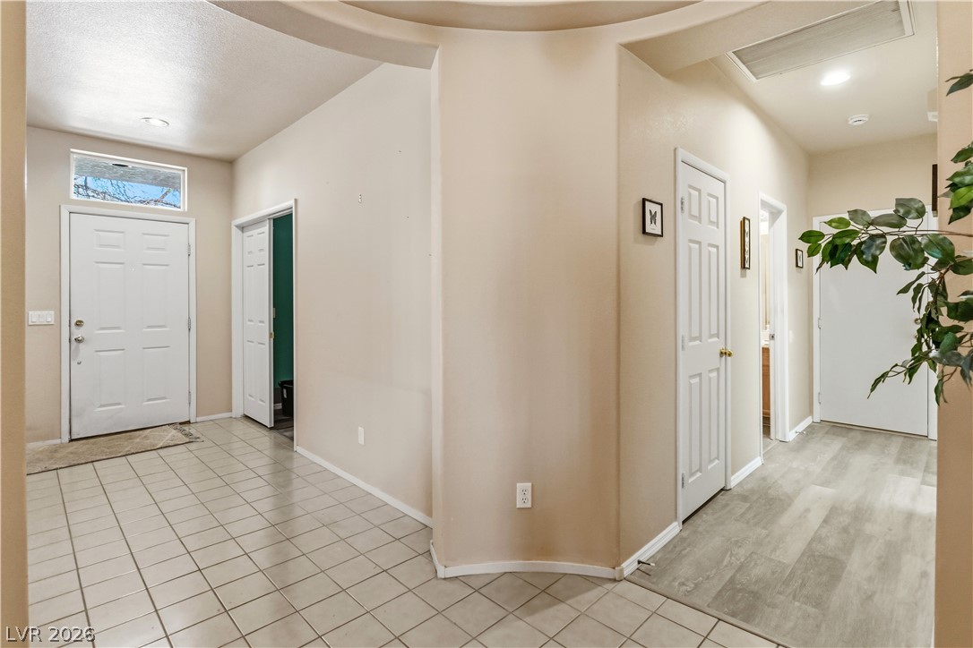 2823 Rippling Springs Street Laughlin, NV 89029 - Photo 39 of 89 Hallway to Second Bedroom, Laundry room, and Garage featuring light tile patterned floors and baseboards