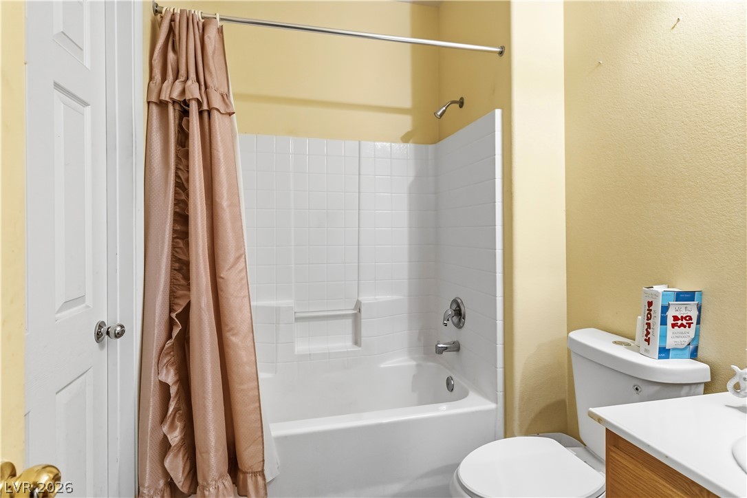 2823 Rippling Springs Street Laughlin, NV 89029 - Photo 41 of 89 Hall Full Bathroom with vanity, a textured wall, and shower / bath combination with curtain