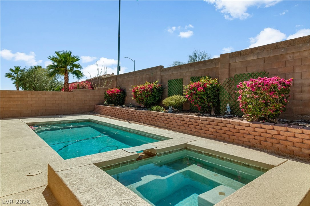2823 Rippling Springs Street Laughlin, NV 89029 - Photo 61 of 89 View of swimming pool with patio surround, an in-ground hot tub, and a fenced backyard