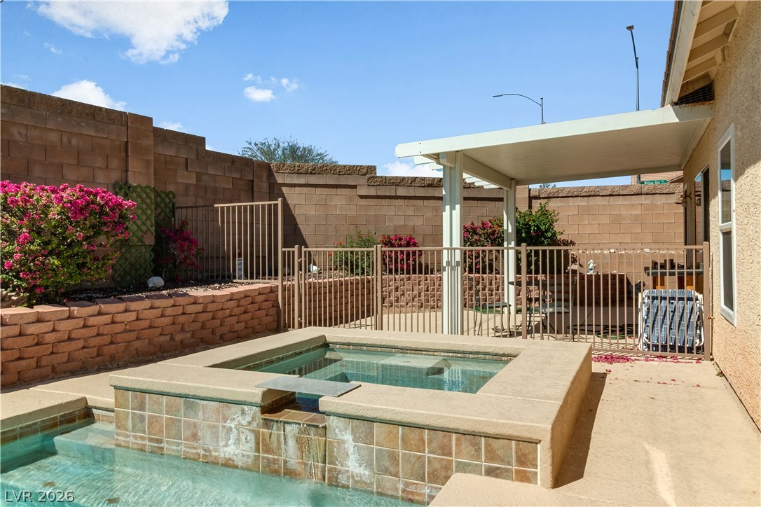 2823 Rippling Springs Street Laughlin, NV 89029 - Photo 69 of 89 View of swimming pool featuring patio surround and an in-ground hot tub