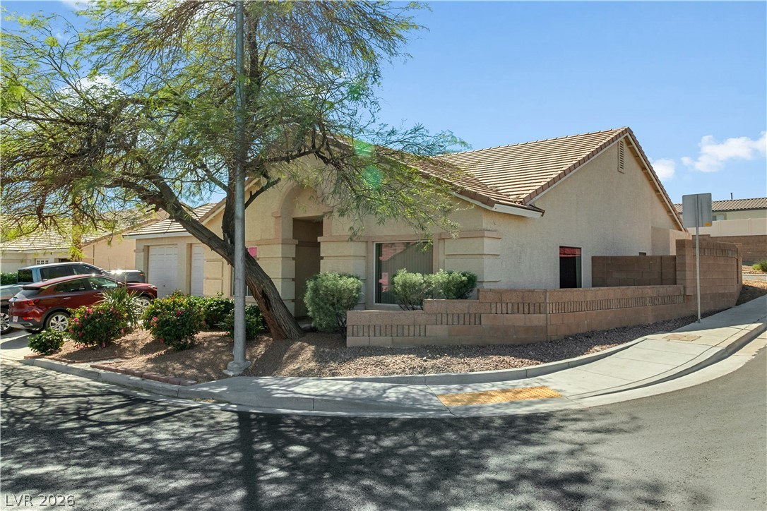 2823 Rippling Springs Street Laughlin, NV 89029 - Photo 73 of 89 View of front facade with stucco siding, a garage, and a tiled roof
